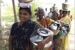 Women in Tamil Nadu, India, carrying water to their homes.