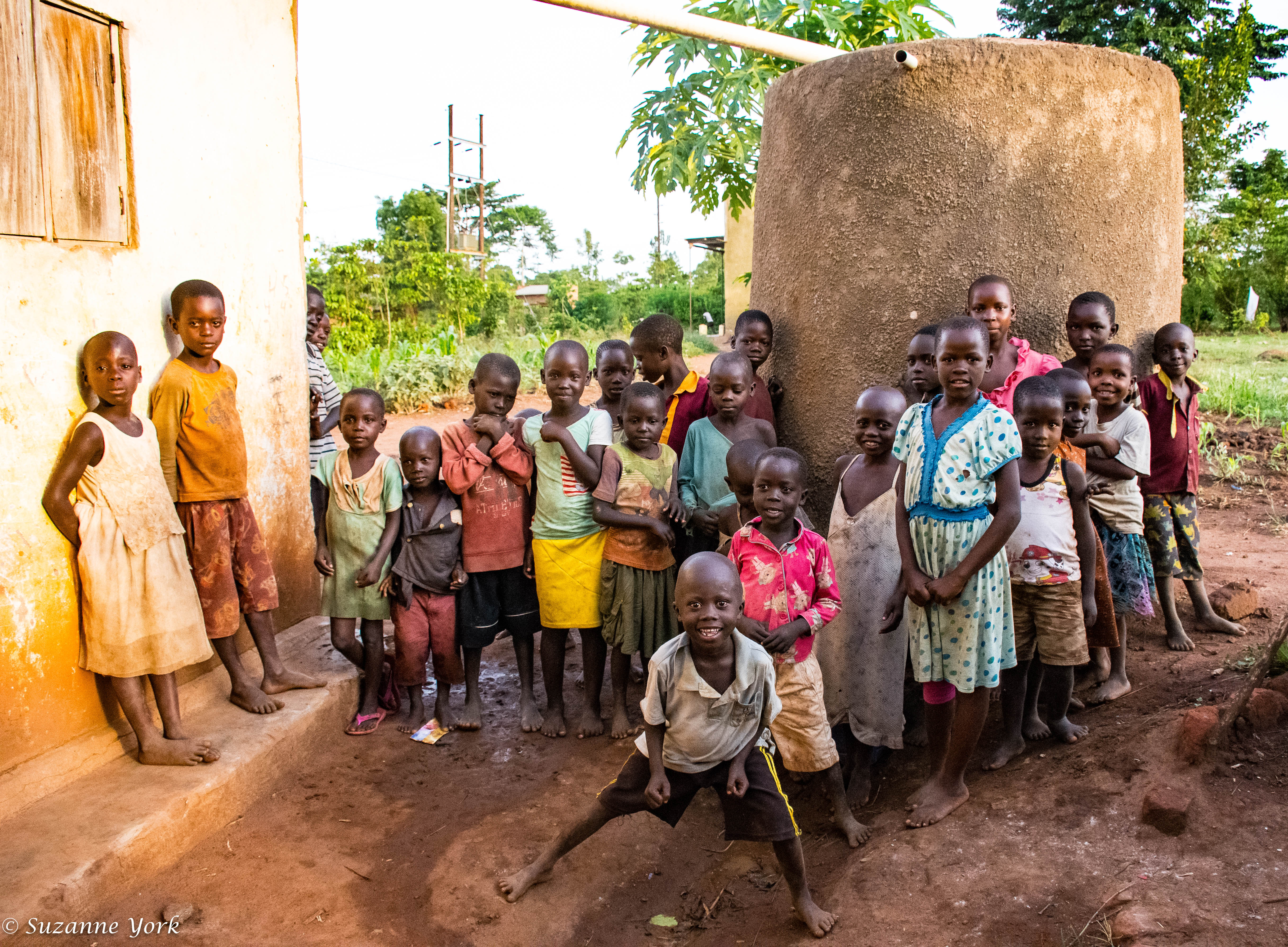 School children in Kayunga District in front of a completed rainwater harvesting tank.