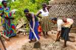 Women building rainwater harvesting tanks