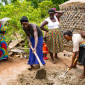 Women building rainwater harvesting tanks