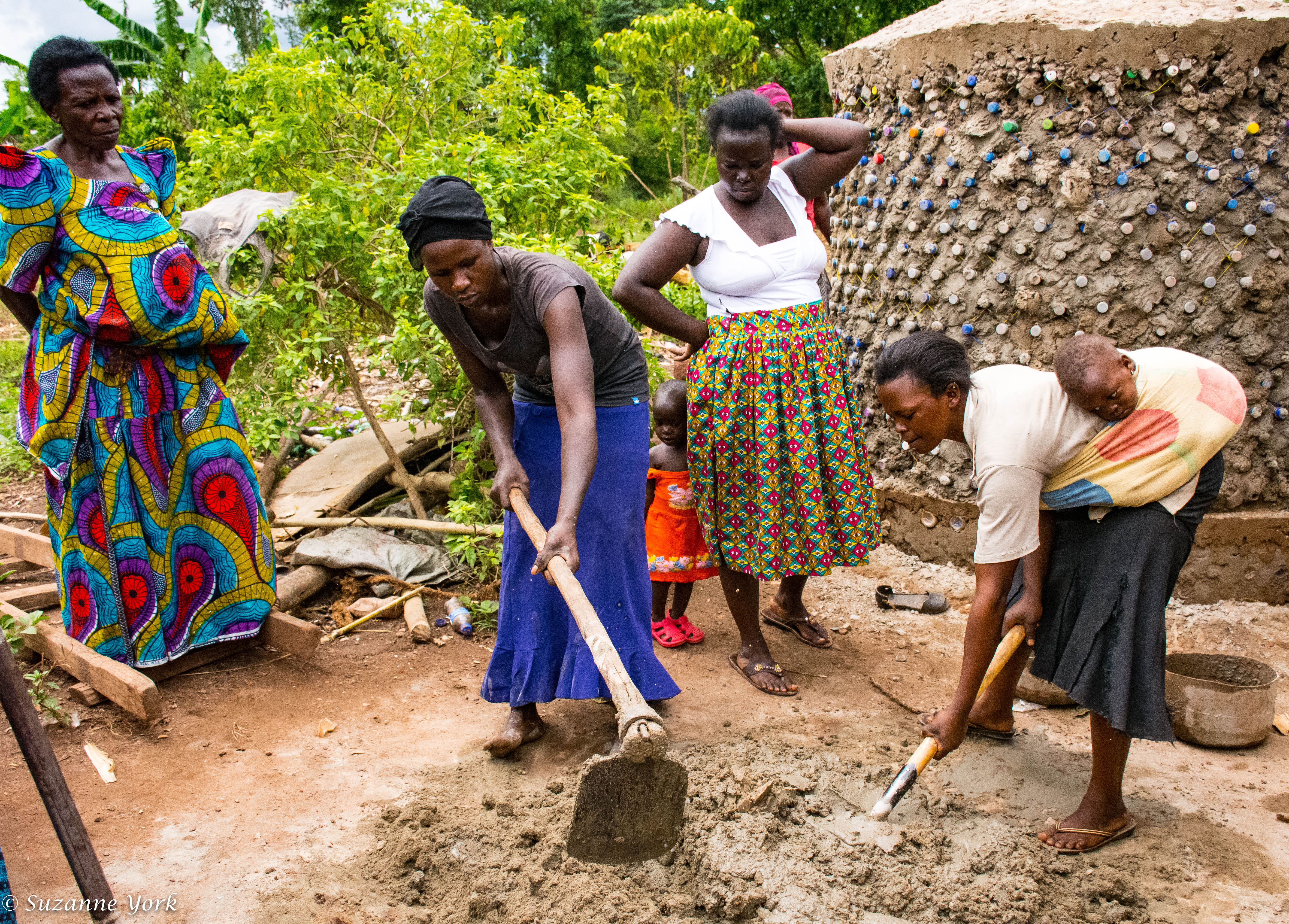Women building rainwater harvesting tanks 
